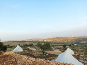 two white tents in a field with a hill at Barrieh in Rammūn