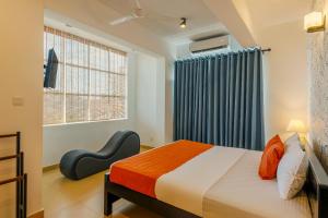 a bedroom with a bed and a window at Beverly Hills Hotel in Mount Lavinia