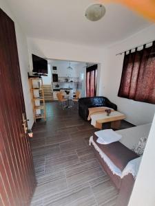 a living room with a couch and a table at Apartmani Dušica in Lumbarda