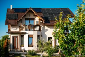 a house with solar panels on the roof at Casa Dora in Suceava