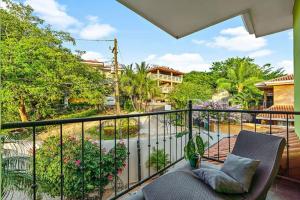 a balcony with two chairs and a view of a garden at Casa Mojito~Serene 2 bedroom with prime location! in Tamarindo