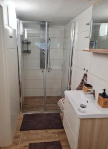 a bathroom with a shower and a sink at Hygge Apartment in Warstein