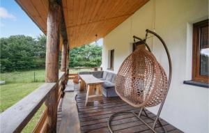 a porch with a couch and a swing on a deck at 3 Bedroom Gorgeous Home In Nidzica in Nidzica