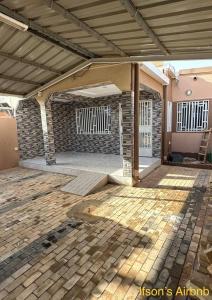 a patio of a house with a brick wall at Ifson Home_1 in Kankamsen