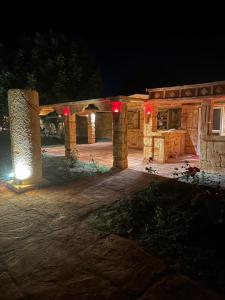 a stone building with red lights at night at Lion Village in Skala Fourkas