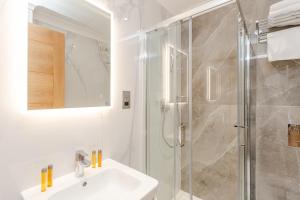 a bathroom with a sink and a shower at Cleveland Residences Chelsea in London