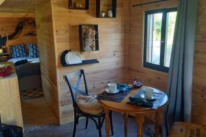 a dining room with a table and chairs in a cabin at La Bohème in Surville