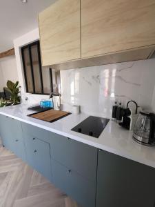 a kitchen with a sink and a counter top at Appartement des Augustins in Aix-en-Provence +2 photos