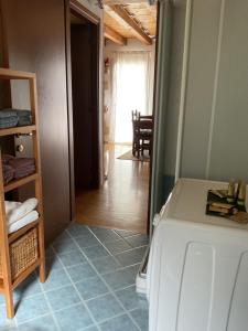 a laundry room with a refrigerator and a hallway at Mountain Living Apartment Asiago in Lusiana