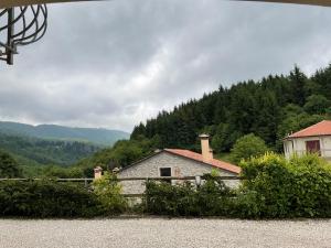 a stone building with trees in the background at Mountain Living Apartment Asiago in Lusiana