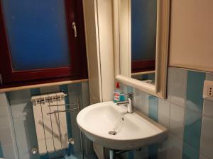 a bathroom with a white sink and a mirror at A casa di Milena in Porto Recanati