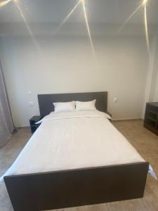 uma grande cama branca num quarto com luzes em Lemon em Costinesti