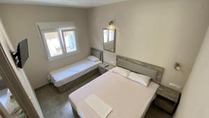 Postel nebo postele na pokoji v ubytování Kalouda Rooms