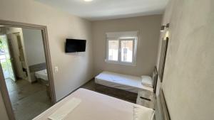 Postel nebo postele na pokoji v ubytování Kalouda Rooms