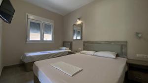 Postel nebo postele na pokoji v ubytování Kalouda Rooms
