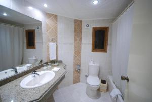 a bathroom with a sink and a toilet and a tub at Sharm al-Sheikh, Egypt - Hotel Apartment in Sharm El Sheikh