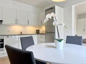 コペンハーゲンにあるCozy One Bedroom Apartment On Edvard Thomsens Vej,のキッチン(花瓶付きの白いテーブル付)