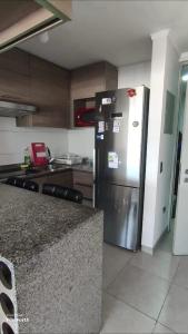 a kitchen with a stainless steel refrigerator in it at Iquique, ED. MATIZ CAVANCHA in Iquique
