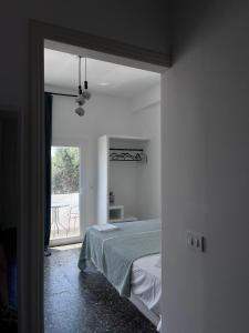 a bedroom with a bed and a view of a patio at suite diminutif in Adamas
