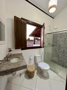 a bathroom with a toilet and a sink and a shower at D'Ajuda Inn in Arraial d'Ajuda