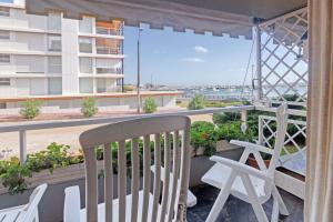 a balcony with chairs and a view of a building at Oceana Suites Remanso in Punta del Este +24 photos
