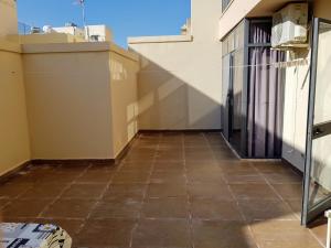 a view from the balcony of a house with a tile floor at Charming apartment-wifi-sleeps 5 in Marsaskala