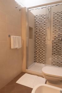 a bathroom with a shower and a toilet at Casa Amato_2_Regina Giovanna in Naples