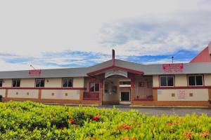 a building with red signs on the front of it at Hotel Residencial Panamericano in David