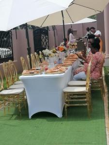 a group of people sitting at a long table at Lady D Exclusive Abode in Polokwane