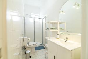 a white bathroom with a toilet and a sink at Livramento Residence in Livramento +29 photos