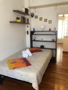 a bedroom with a bed with a colorful blanket on it at Annarosa in Sarzana