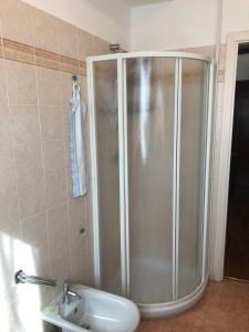 a shower in a bathroom with a sink at Annarosa in Sarzana +2 photos