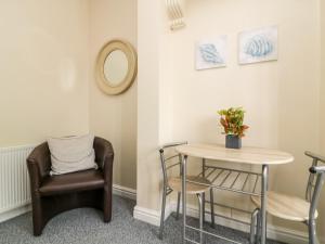 a room with a table and a chair at Seashells in Hornsea