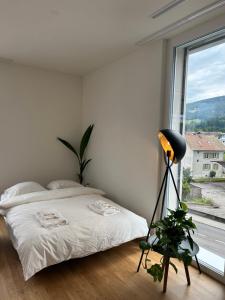 Postel nebo postele na pokoji v ubytování The R Apartment Engelberg, KLIMA, NEU, Balkon, Parking