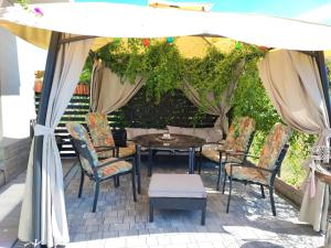 a table and chairs under an umbrella on a patio at 4 Foxes in Ustka