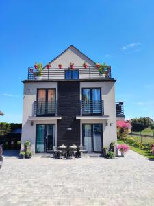 a house with tables and chairs in front of it at 4 Foxes in Ustka
