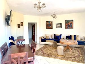 a living room with a table and a couch at Bahia golf beach in Bouznika