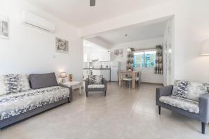 a living room with a couch and chairs and a table at Lemon Tree Villa in Paralimni
