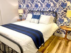 a bedroom with a bed with blue and white wallpaper at Chalet Retreat w/ Hot Tub, Short Walk to Lake & Pool in Jim Thorpe