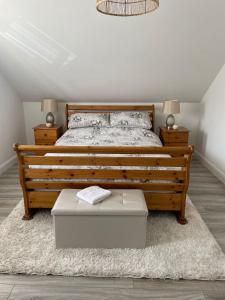 a bedroom with a large wooden bed and a rug at Grianan view loft apartment in Tieveborne