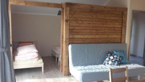 a bedroom with a bed and a bed and a crib at Apartmány Audy 2 in Mníšek pod Brdy