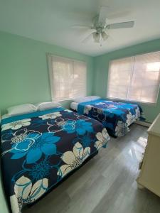 a bedroom with a bed with a blue comforter at Crystal Sands Phila Ave in Ocean City