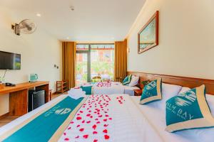a bedroom with two beds with red hearts on them at Palm Bay Resort Phu Quoc in Phú Quốc
