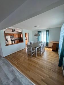 a dining room and living room with a table and chairs at Crystal Sands Phila Ave in Ocean City