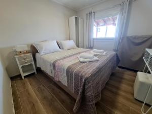 a small bedroom with a bed and a window at Stella's Garden in Paleo Tsifliki