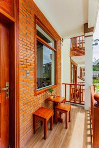 a room with two benches and a brick wall at Palm Bay Resort Phu Quoc in Phú Quốc