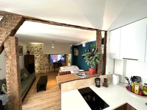 a kitchen and a living room with a counter top at Appartement Vieux Mans in Le Mans