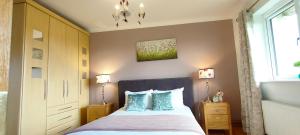 a bedroom with a bed with two pillows and a window at Golf'Inn Enniscrone in Enniscrone