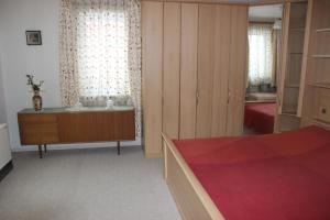 a bedroom with a bed and a dresser and a room at Sleep in Lerbach in Osterode