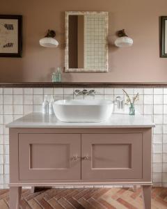 a bathroom with a sink and a mirror at The Kirkstyle Inn & Sportsman Rest in Brampton